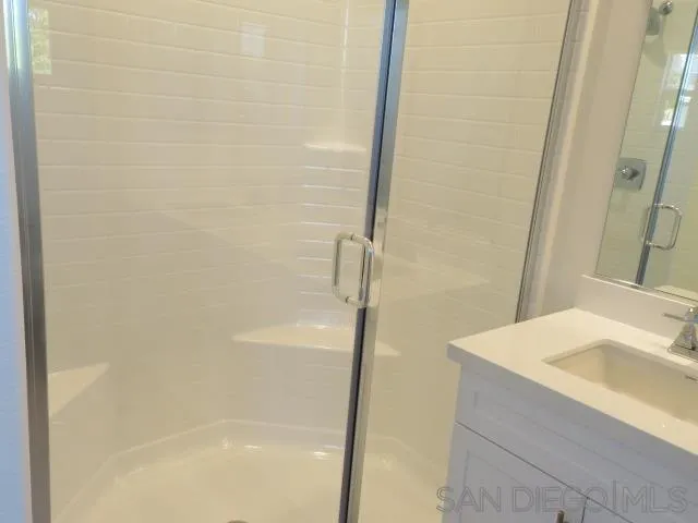 4382 Pacifica Way, Unit 5 Oceanside, CA 92056 - Photo 30 of 35 a bathroom with a sink and a shower