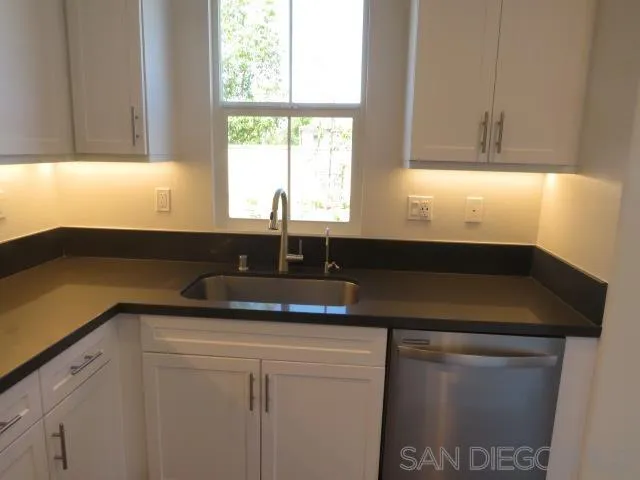 4382 Pacifica Way, Unit 5 Oceanside, CA 92056 - Photo 6 of 35 a kitchen with a sink and cabinets