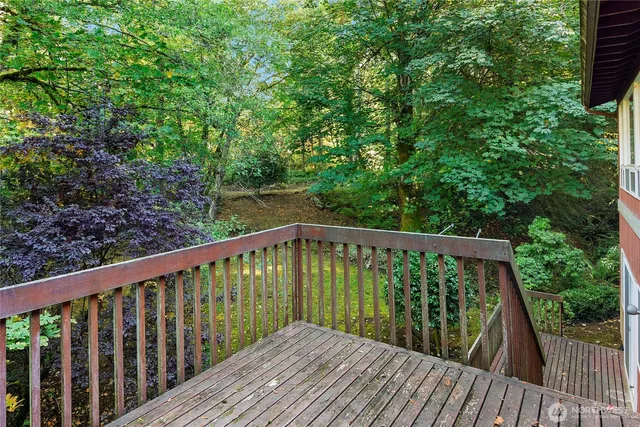 a view of balcony with wooden floor and fence