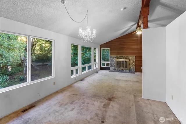 a view of livingroom with furniture fireplace and windows