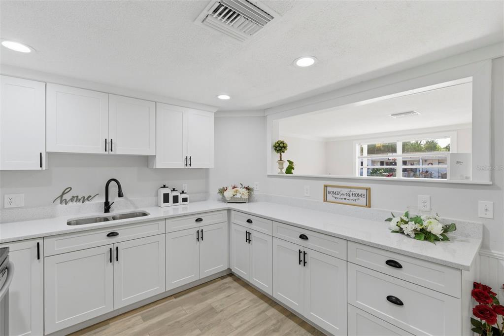 9033 Pegasus Avenue Port Richey, FL 34668 - Photo 14 of 56 a kitchen with white cabinets and sink