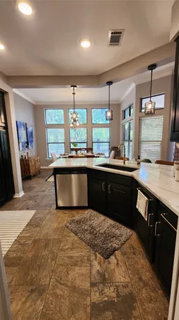 a kitchen with a sink stove and cabinets