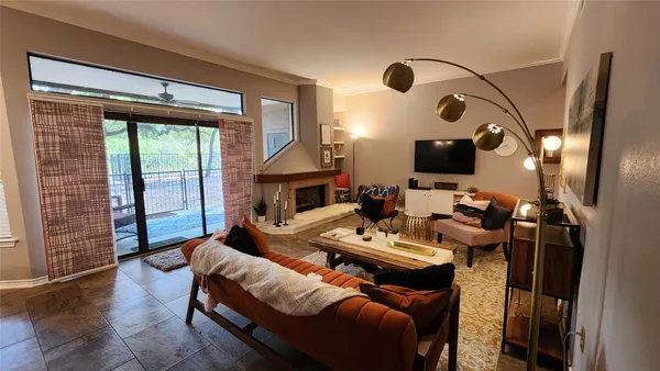 a living room with furniture a fireplace and a flat screen tv