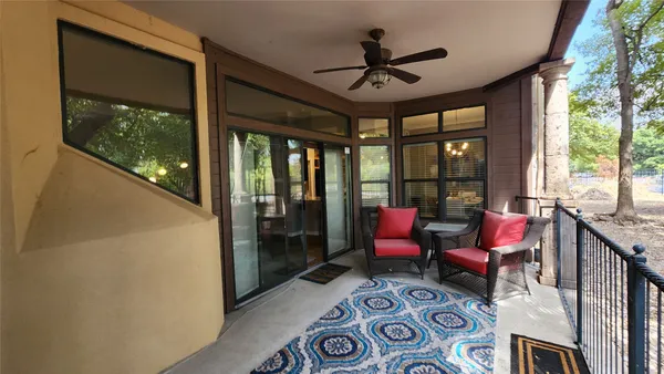 a living room with furniture and a floor to ceiling window