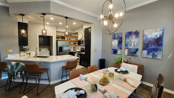 a kitchen with a dining table and chairs