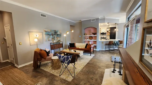 a living room with furniture a rug and a table