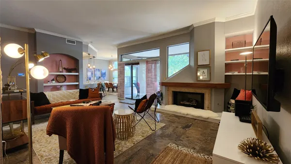 a living room with furniture a fireplace and a flat screen tv