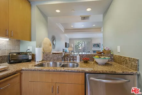 a kitchen with sink stove and cabinets