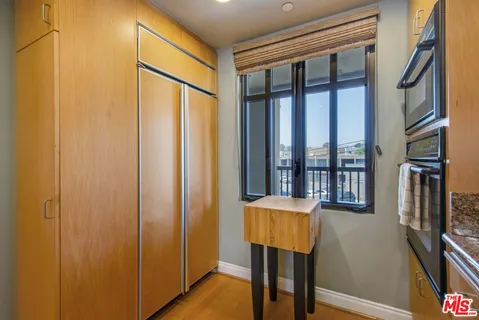 a bedroom with a large bed and a large window