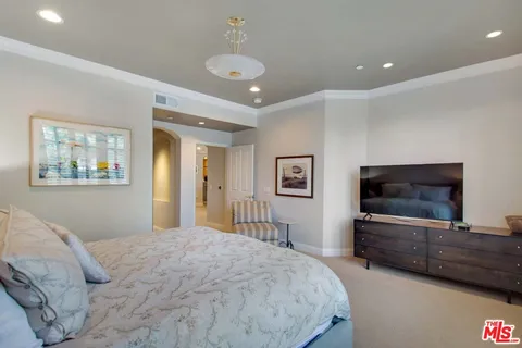 a bathroom with a tub a sink double vanity and a mirror