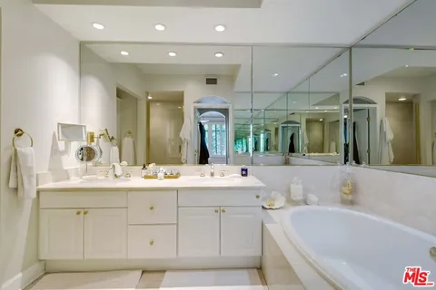 a spacious bathroom with a tub shower and sink