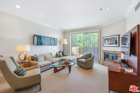 a living room with furniture flat screen tv and a fireplace