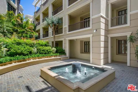 a living room with furniture gym equipment and large windows