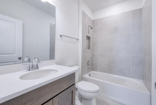 a bathroom with a sink a toilet and a bathtub