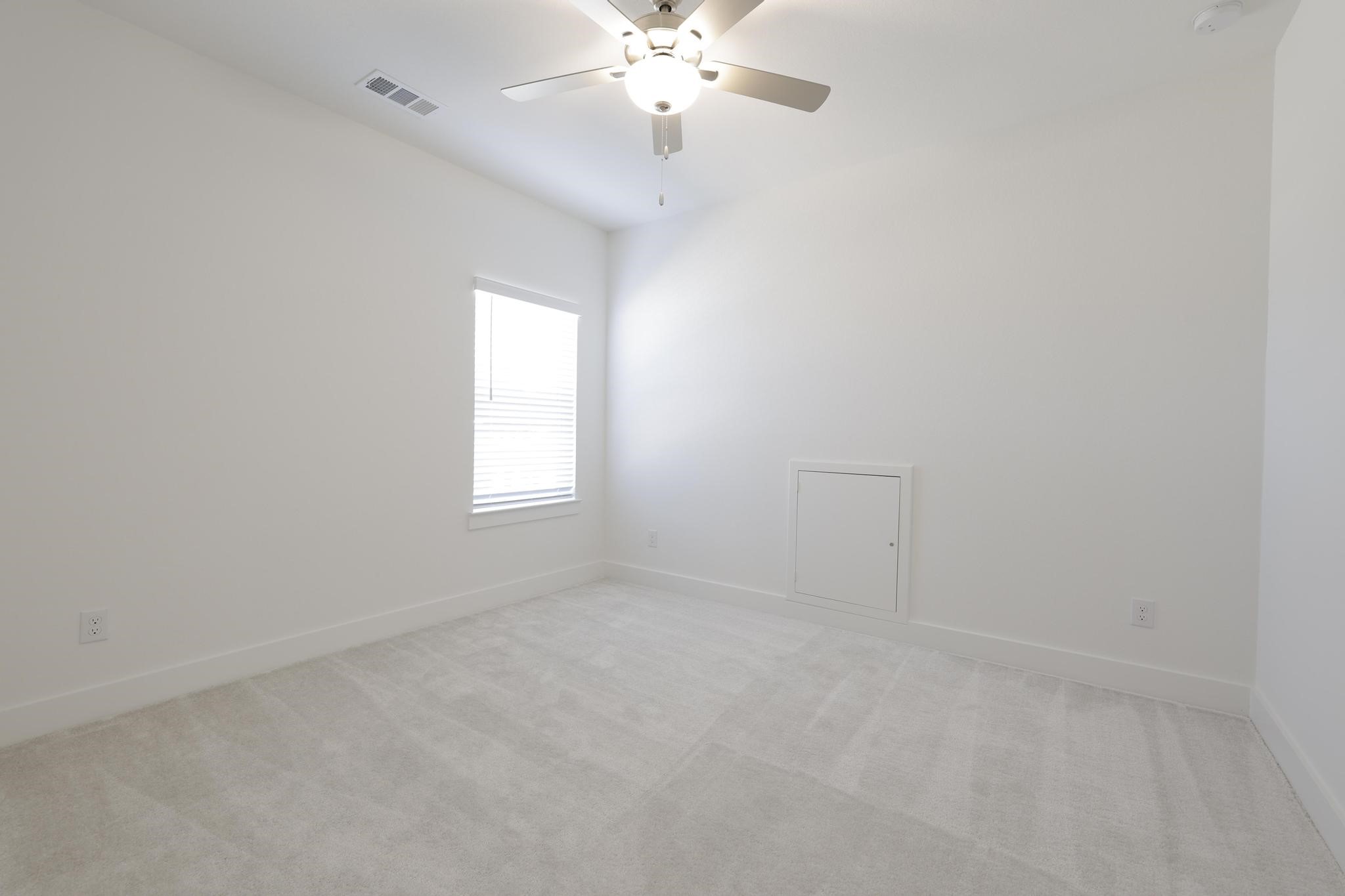 26934 Putnam Bnd Lane Spring, TX 77389 - Photo 17 of 21 an empty room with a chandelier fan and windows