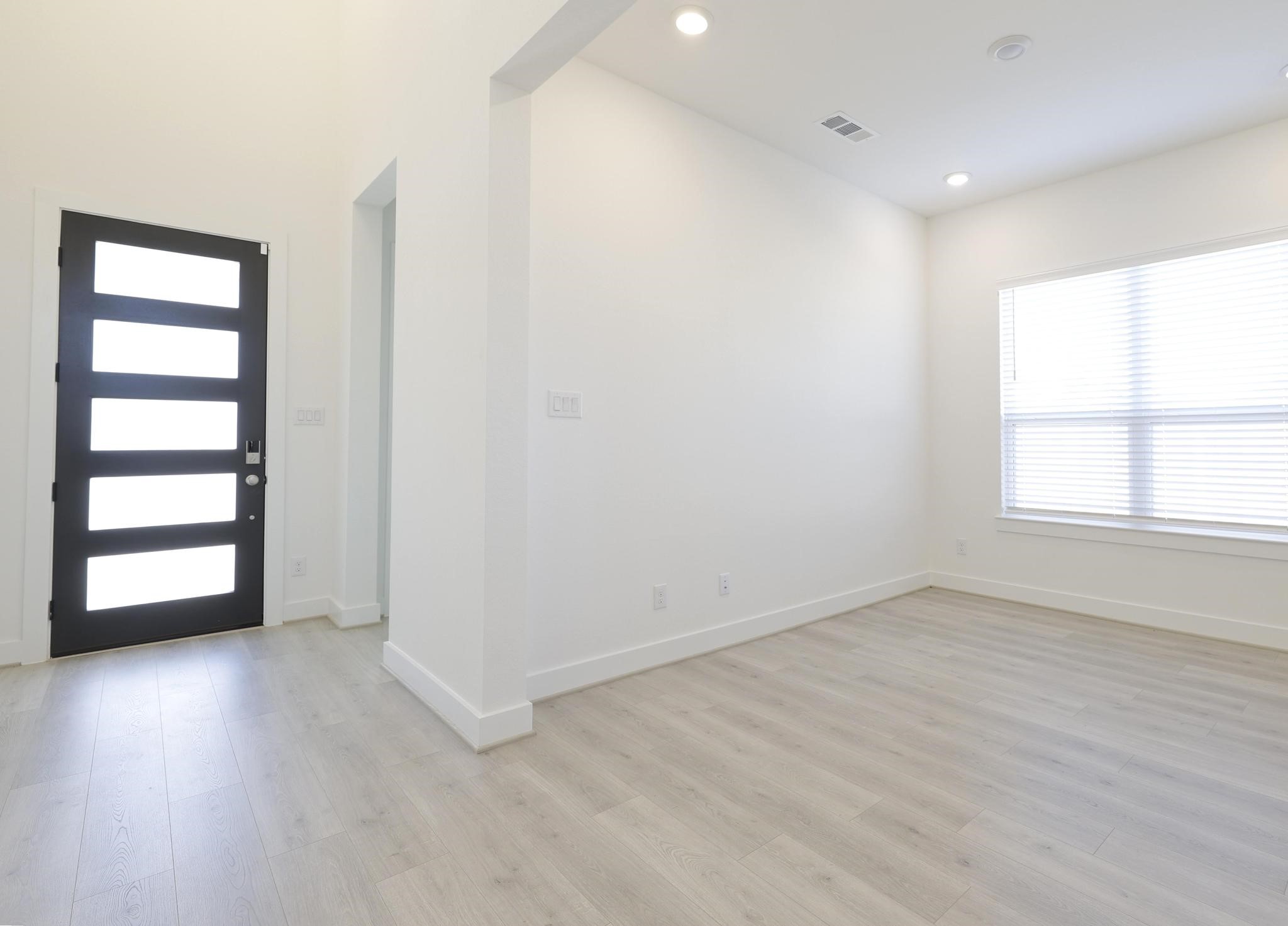 26934 Putnam Bnd Lane Spring, TX 77389 - Photo 4 of 21 an empty room with wooden floor and windows