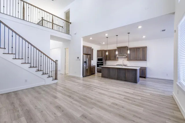 a view of kitchen with cabinets stainless steel appliances wooden floor and window