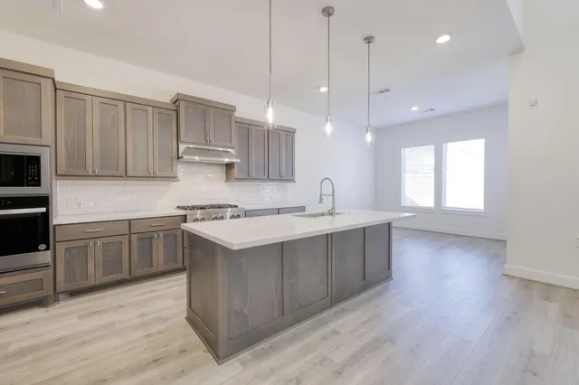 a kitchen with a sink window and cabinets