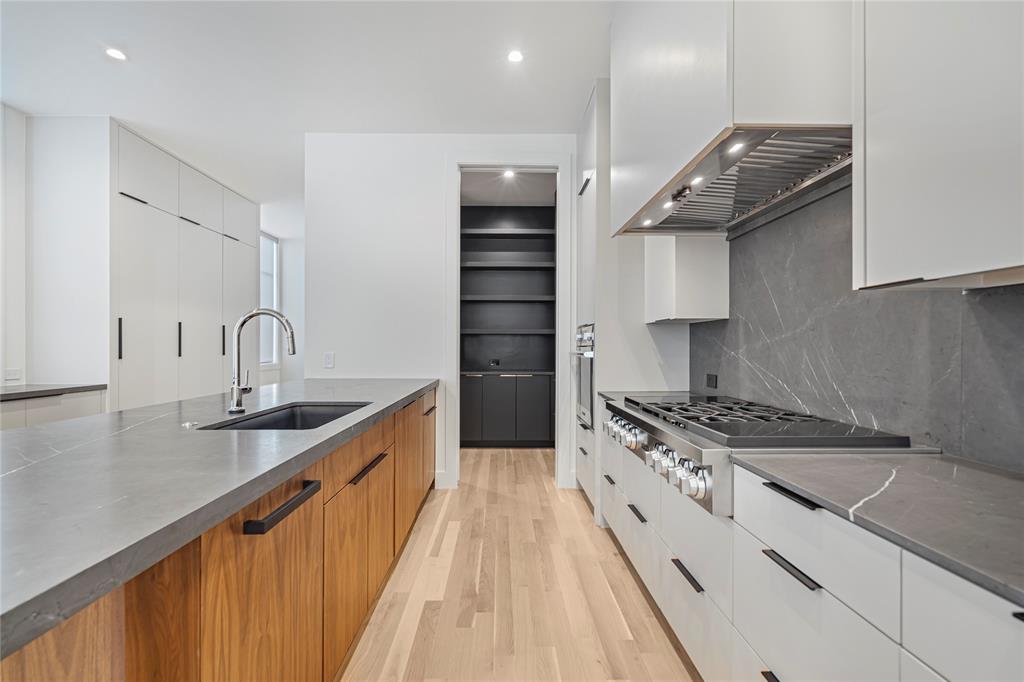 3619 Springbrook Street Dallas, TX 75205 - Photo 16 of 35 a kitchen with granite countertop a sink stove and cabinets