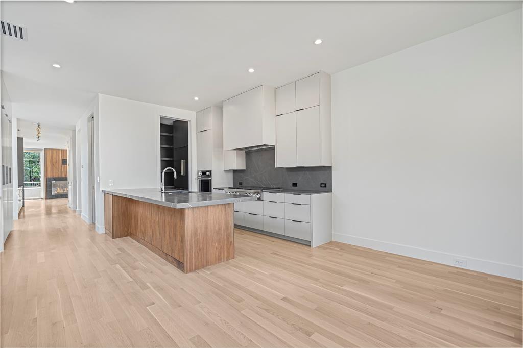 3619 Springbrook Street Dallas, TX 75205 - Photo 17 of 35 a kitchen with stainless steel appliances granite countertop a stove a sink and a refrigerator
