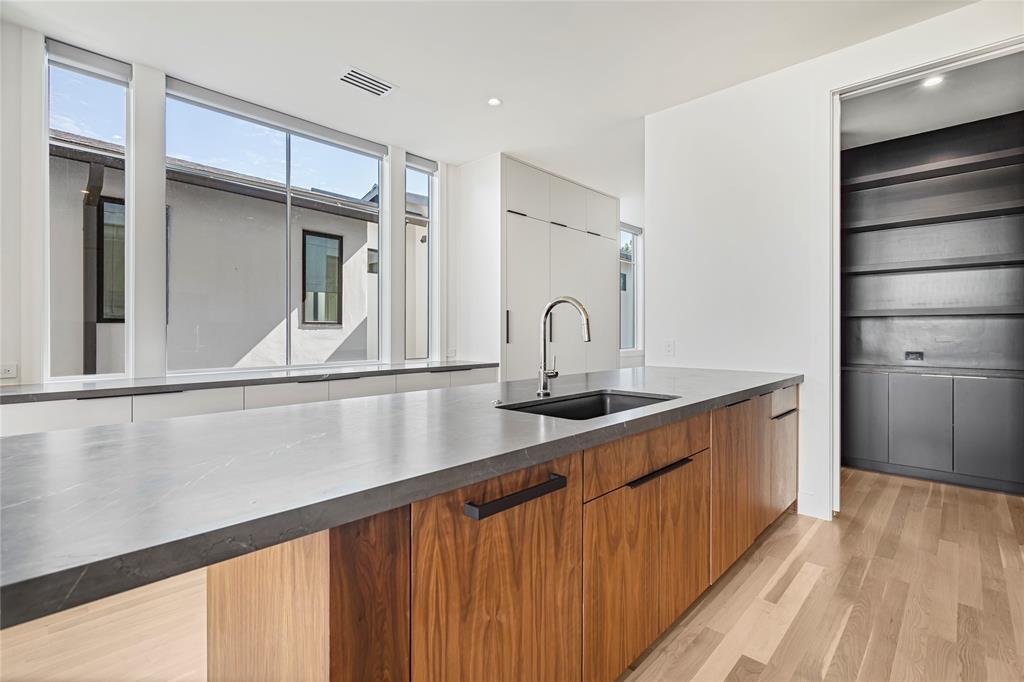 3619 Springbrook Street Dallas, TX 75205 - Photo 18 of 40 a kitchen with a sink and refrigerator