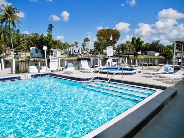 33 Henderson Drive Naples, FL 34114 - Photo 11 of 15 a view of a swimming pool with outdoor seating