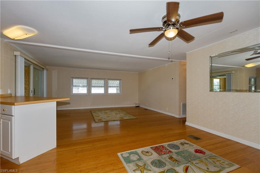 33 Henderson Drive Naples, FL 34114 - Photo 5 of 15 a view of livingroom with hardwood floor and ceiling fan