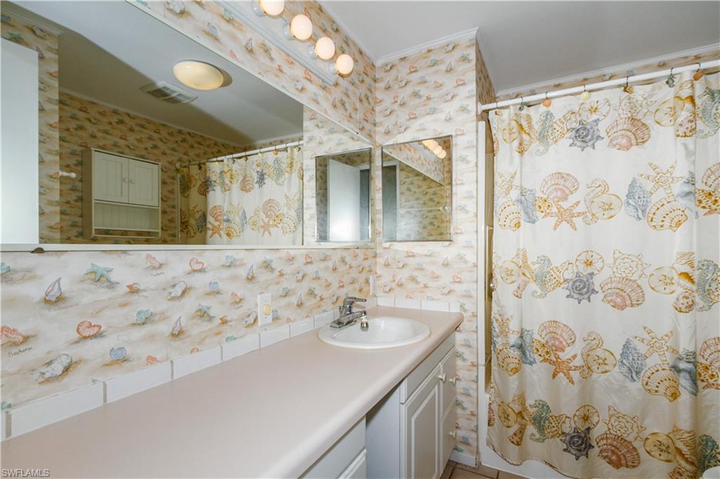 33 Henderson Drive Naples, FL 34114 - Photo 10 of 15 a bathroom with a sink and a mirror