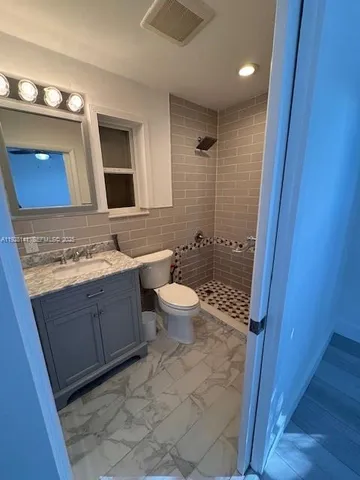 a bathroom with a sink a toilet and mirror