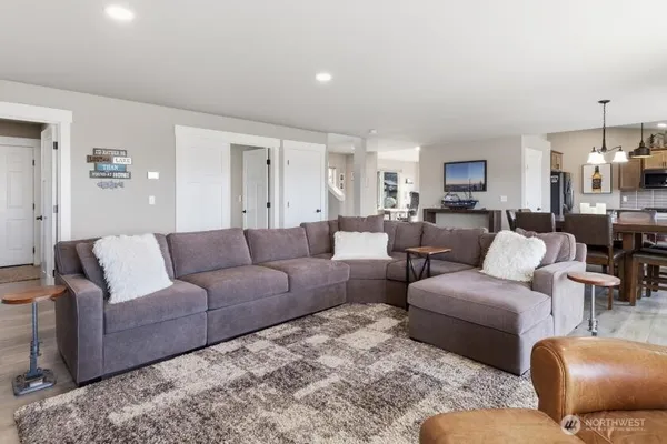 a living room with furniture and a view of kitchen