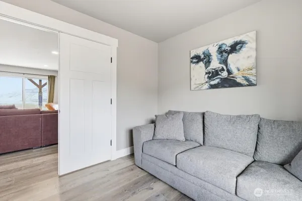 a living room with furniture and a painting on the wall