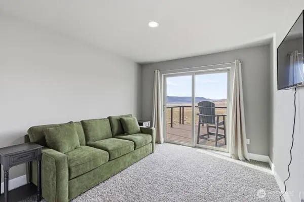 a living room with furniture and a floor to ceiling window