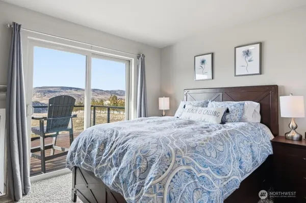 a bedroom with a large bed and a large window