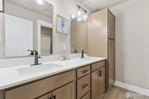 a bathroom with a sink double vanity and a mirror