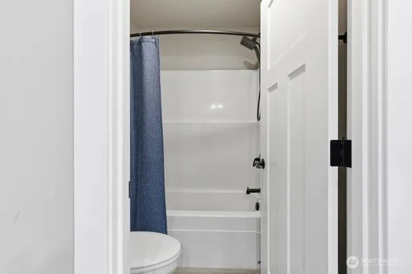 a bathroom with a shower and a toilet