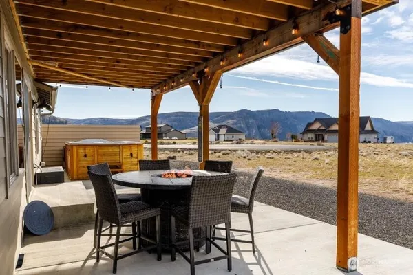 a dining area with furniture and outdoor space
