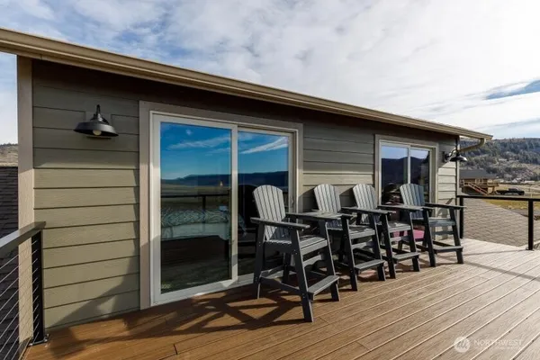 a view of deck with table and chairs and wooden floor