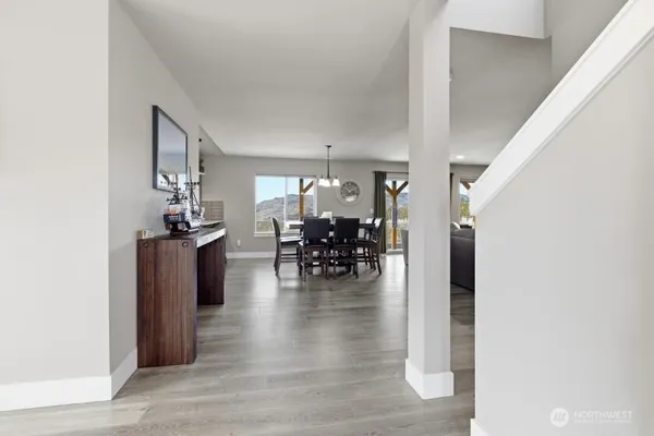a dining room with furniture and wooden floor