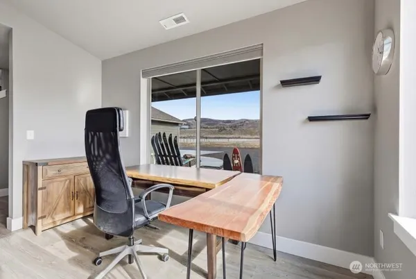 a view of a dining room with furniture and a window