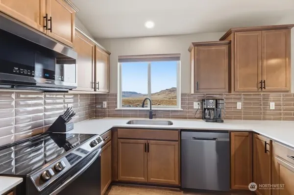 a kitchen with a sink stove top oven and cabinets