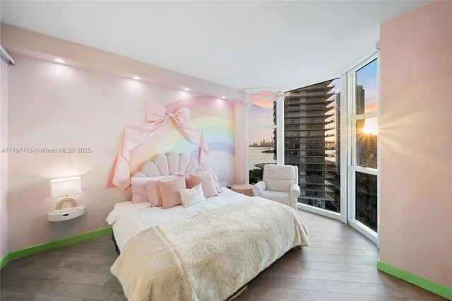 a bedroom with a bed and a flat tv screen on dresser