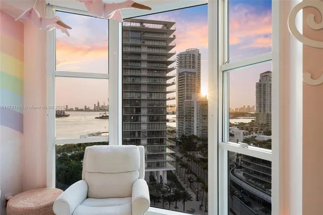 a bathroom with a shower curtain and a view of a bathroom