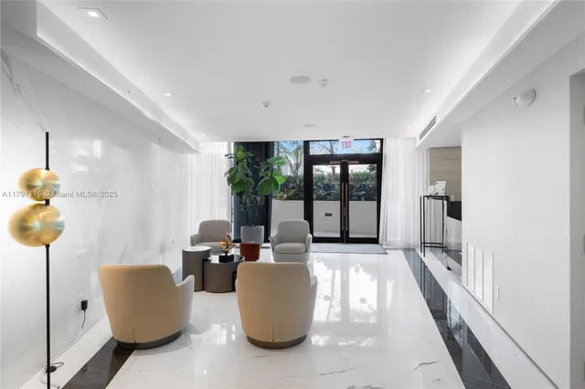 a living room with furniture and a floor to ceiling window