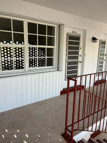 a living room with lots of furniture and white walls