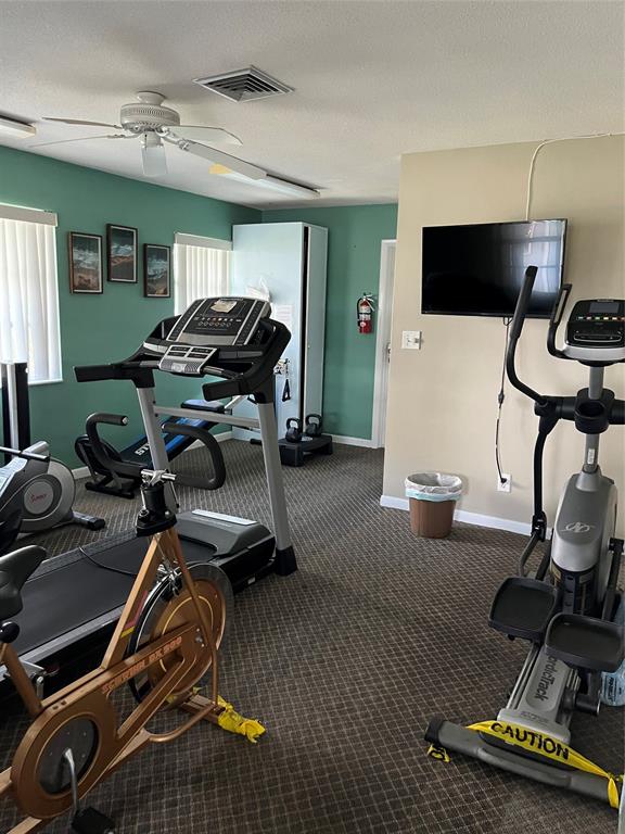 2050 Northeast 39th Street, Unit 312E Lighthouse Point, FL 33064 - Photo 15 of 17 a room with gym equipment and windows