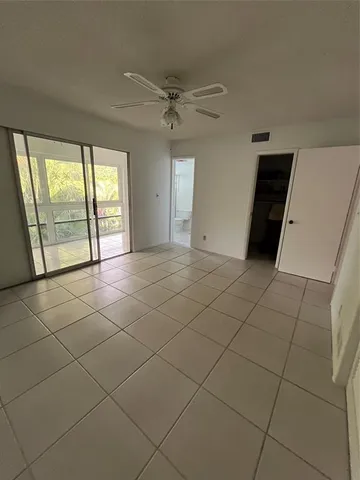 a bathroom with a granite countertop sink a toilet and a shower
