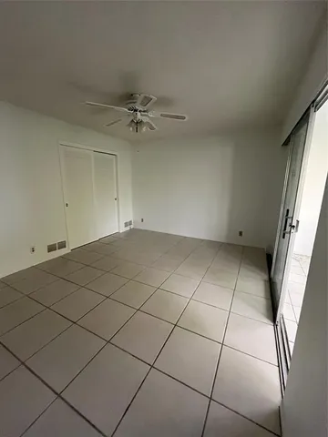 a view of an empty room with a floor to ceiling window and an outdoor view