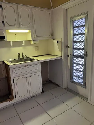 a kitchen with stainless steel appliances granite countertop a sink and a stove