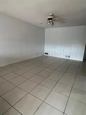 a kitchen with white cabinets and window