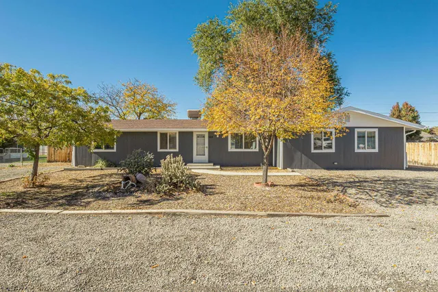 a backyard of a house with table and chairs